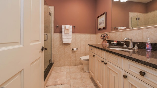 full bathroom featuring toilet, a stall shower, vanity, and tile patterned floors