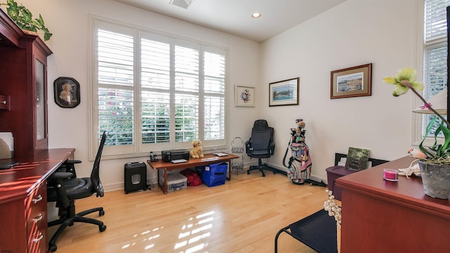 office space with recessed lighting, wood finished floors, visible vents, and baseboards