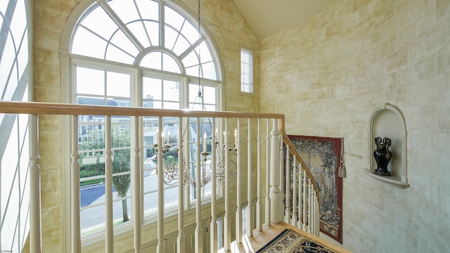 interior space with vaulted ceiling and tile walls