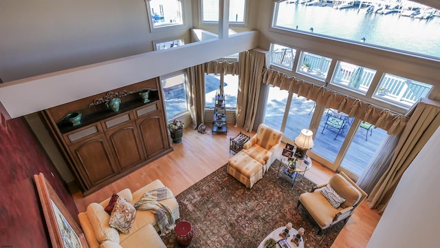 living room with a high ceiling and light wood finished floors