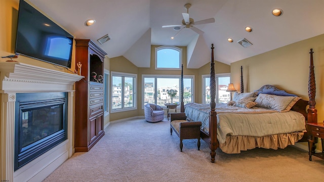 bedroom with recessed lighting, a glass covered fireplace, visible vents, and light colored carpet