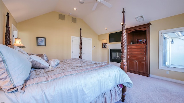 bedroom featuring lofted ceiling, carpet floors, and visible vents