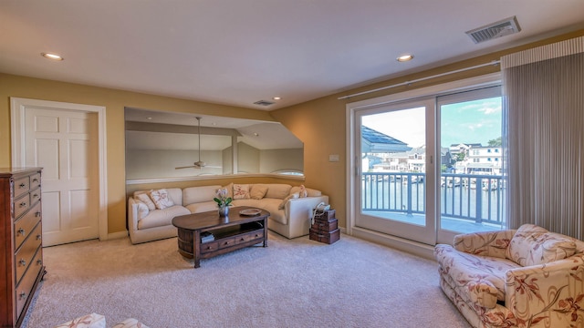 living area featuring light carpet, visible vents, and recessed lighting