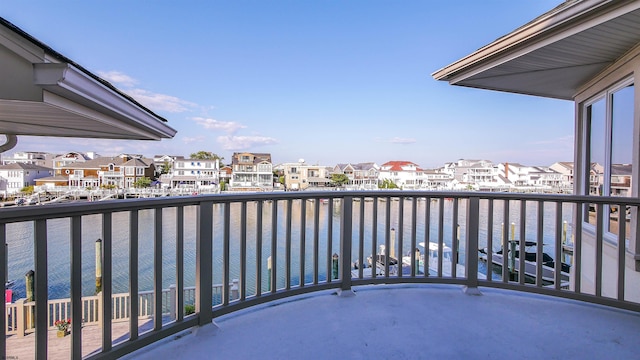 balcony with a water view and a residential view