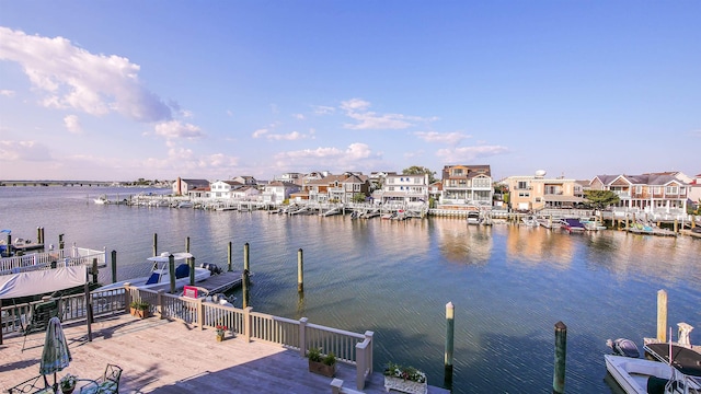 view of dock with a residential view and a water view