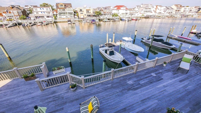 dock area with a water view and a residential view