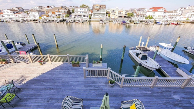 view of dock featuring a residential view and a water view