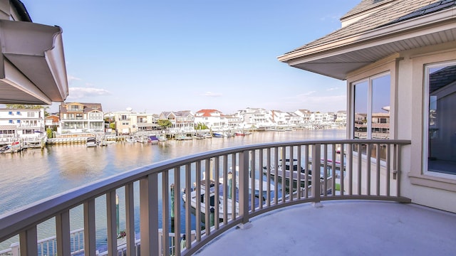 balcony featuring a water view and a residential view