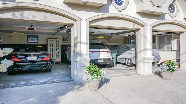 exterior space featuring concrete driveway and stucco siding