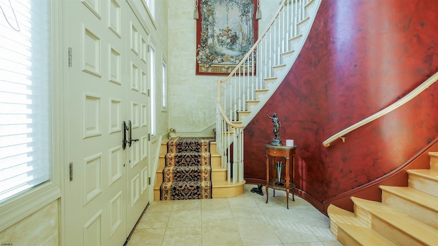 tiled foyer featuring stairs