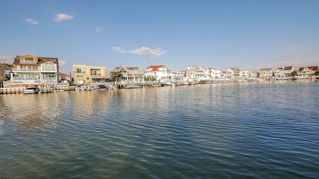 property view of water featuring a boat dock and a residential view