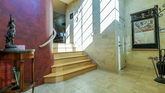 stairway with tile patterned flooring