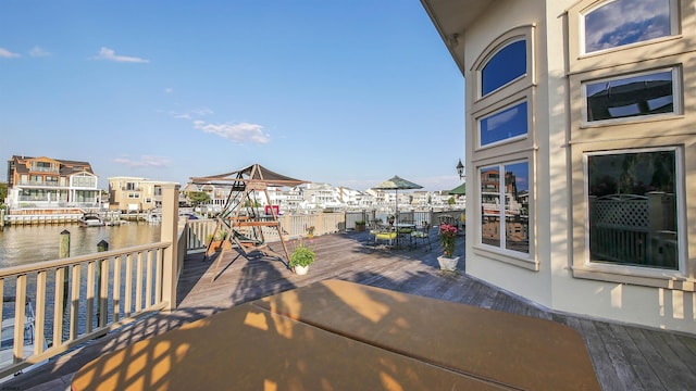 exterior space with outdoor dining space and a water view