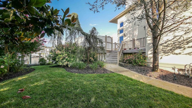 view of yard featuring stairway and a wooden deck