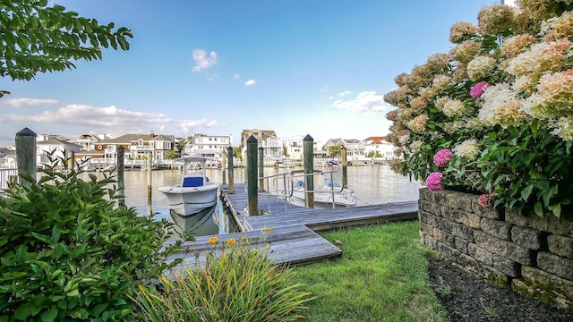 dock area featuring boat lift and a residential view