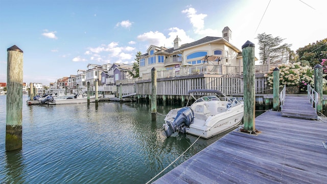 dock area featuring a water view and a residential view