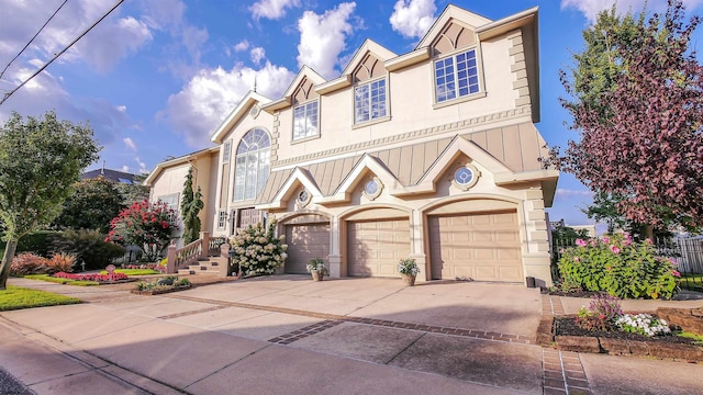 view of property featuring a garage, concrete driveway, and stucco siding