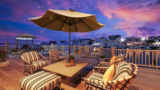 deck at dusk with an outdoor living space