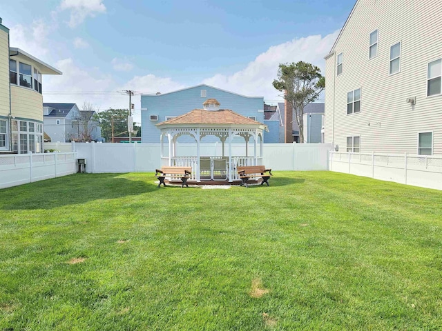 view of yard featuring a gazebo and a fenced backyard