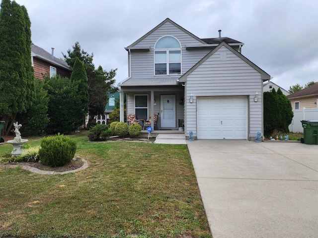 traditional home featuring an attached garage, concrete driveway, covered porch, and a front yard