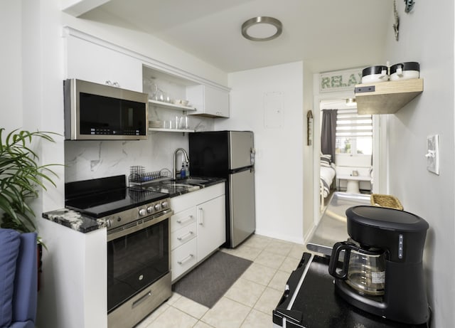 kitchen featuring appliances with stainless steel finishes, white cabinetry, backsplash, and open shelves