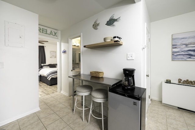 kitchen with electric panel, light tile patterned flooring, open shelves, and refrigerator