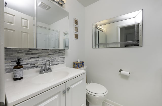 full bath with toilet, vanity, visible vents, tasteful backsplash, and a shower with door