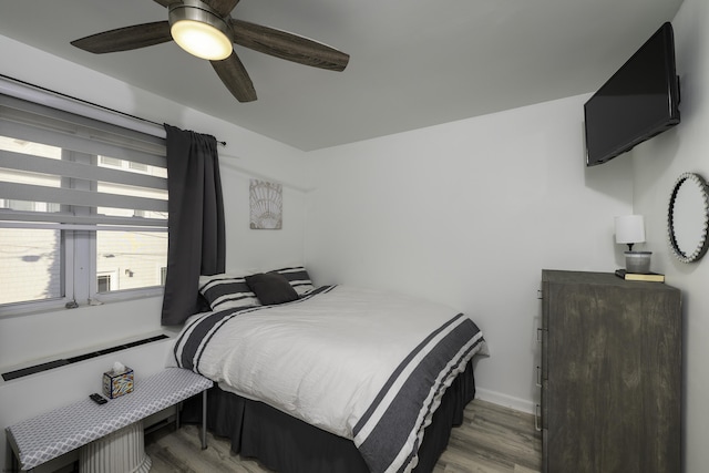 bedroom featuring light wood-type flooring and ceiling fan