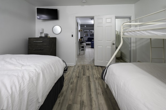 bedroom featuring baseboards and wood finished floors