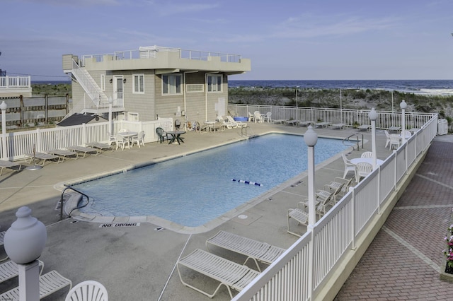 pool featuring a patio area and fence