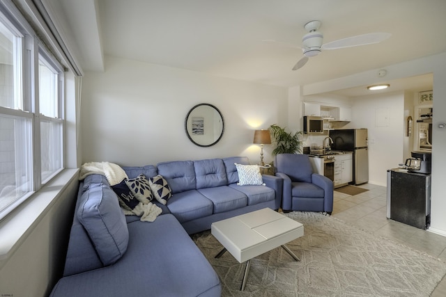 living room featuring ceiling fan and light tile patterned flooring