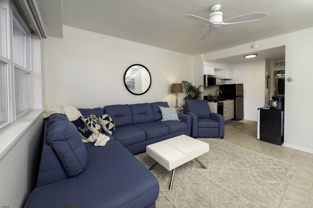 living room featuring a ceiling fan and light tile patterned flooring