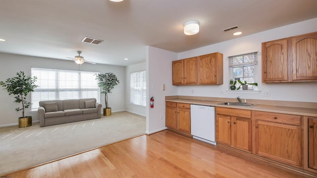 kitchen with white dishwasher, visible vents, open floor plan, and a sink