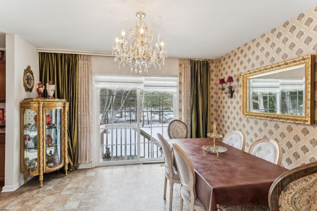 dining space featuring baseboards, an inviting chandelier, and wallpapered walls