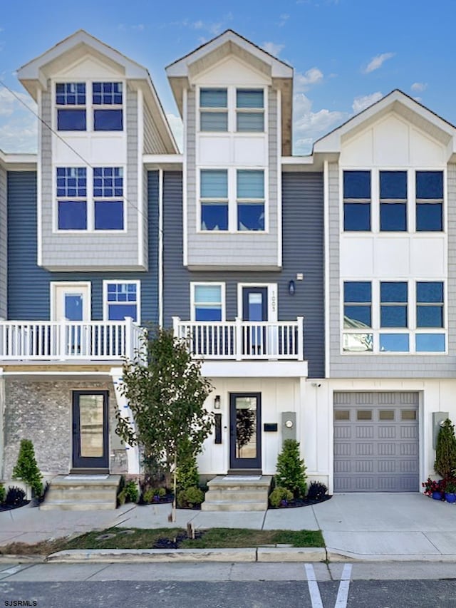 townhome / multi-family property featuring driveway, a garage, and board and batten siding