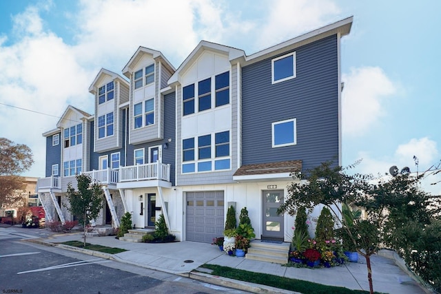 multi unit property with an attached garage, board and batten siding, and concrete driveway