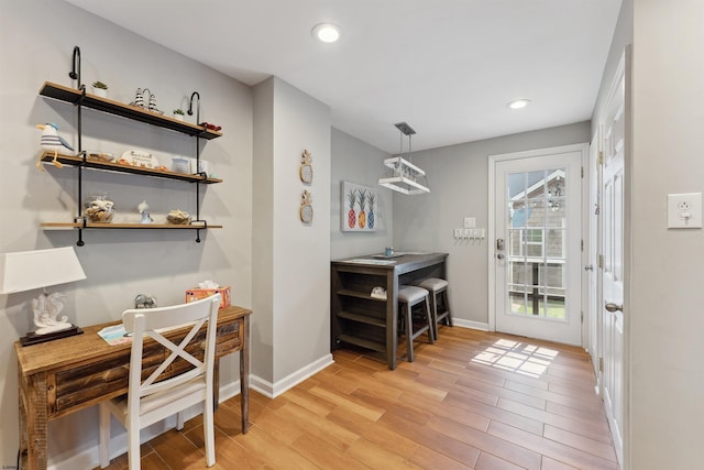 office space featuring light wood-style floors, recessed lighting, and baseboards