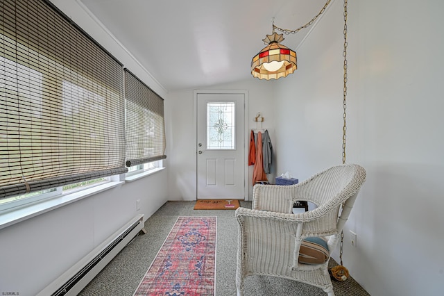 interior space featuring a baseboard heating unit, vaulted ceiling, and carpet flooring