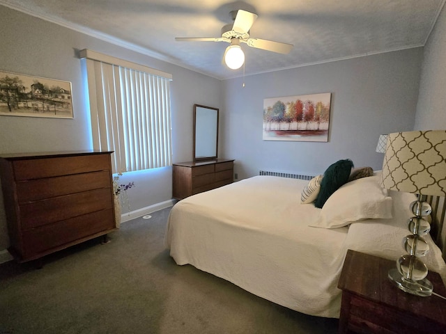 bedroom featuring ornamental molding, dark colored carpet, and a ceiling fan