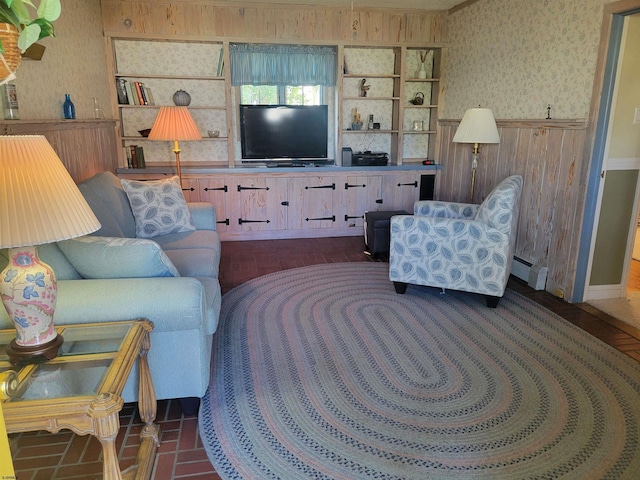 living area with wainscoting, a baseboard radiator, and wallpapered walls