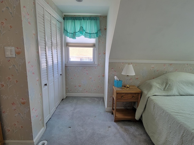 bedroom with wallpapered walls, baseboards, and light colored carpet