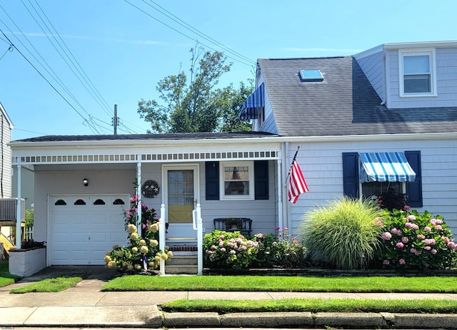 view of front of property with a garage, driveway, and a shingled roof