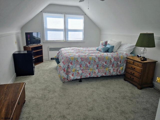 bedroom featuring carpet floors, ceiling fan, radiator heating unit, and vaulted ceiling