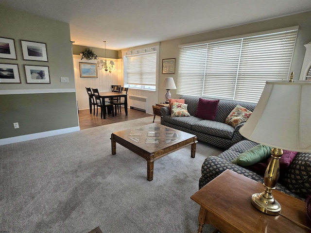 living room with carpet, baseboards, and radiator heating unit