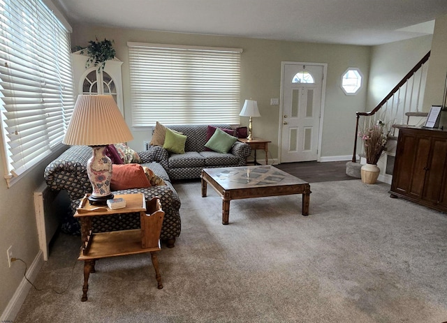 living room featuring baseboards, stairway, and carpet flooring