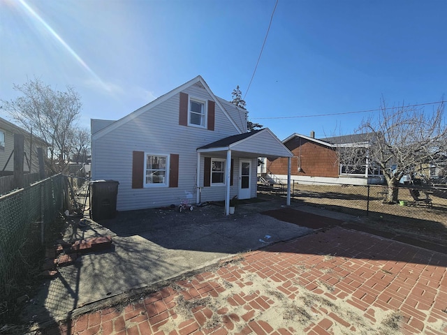 view of front of property with fence private yard and a patio