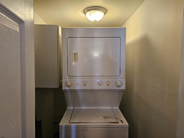 washroom featuring laundry area and stacked washer / drying machine