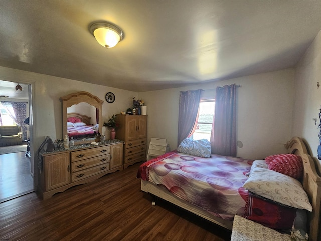 bedroom with dark wood-type flooring