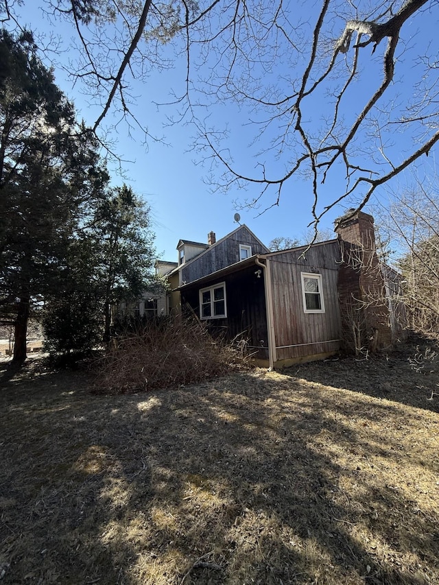 back of property with a chimney