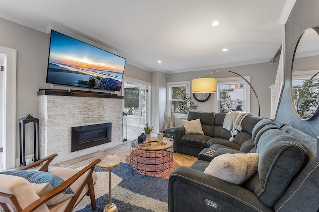 living room with ornamental molding, a fireplace, and recessed lighting